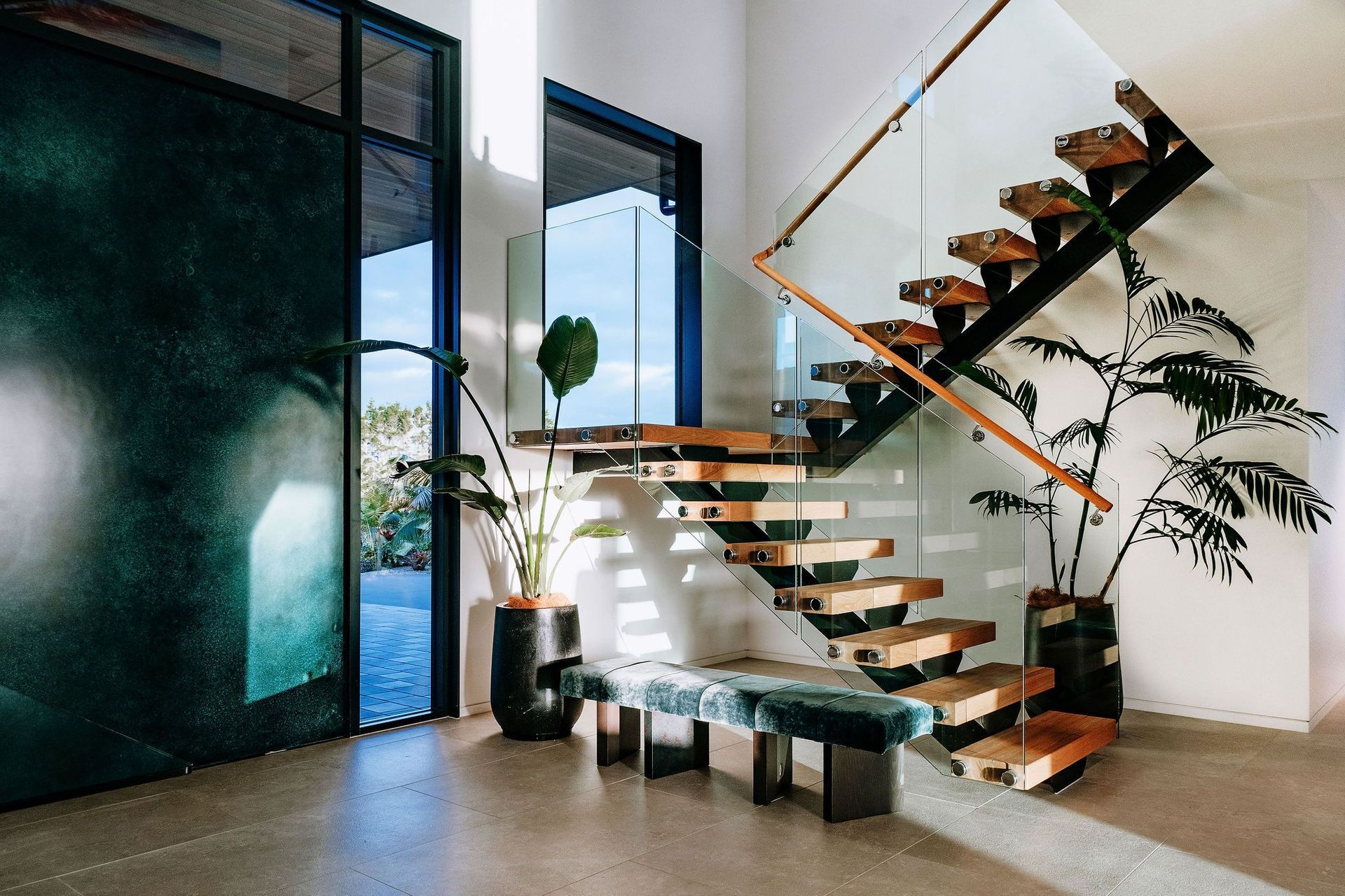 entry-stairs-floating-glass-steel-indoor-plants-seating-arcline-architecture.jpg