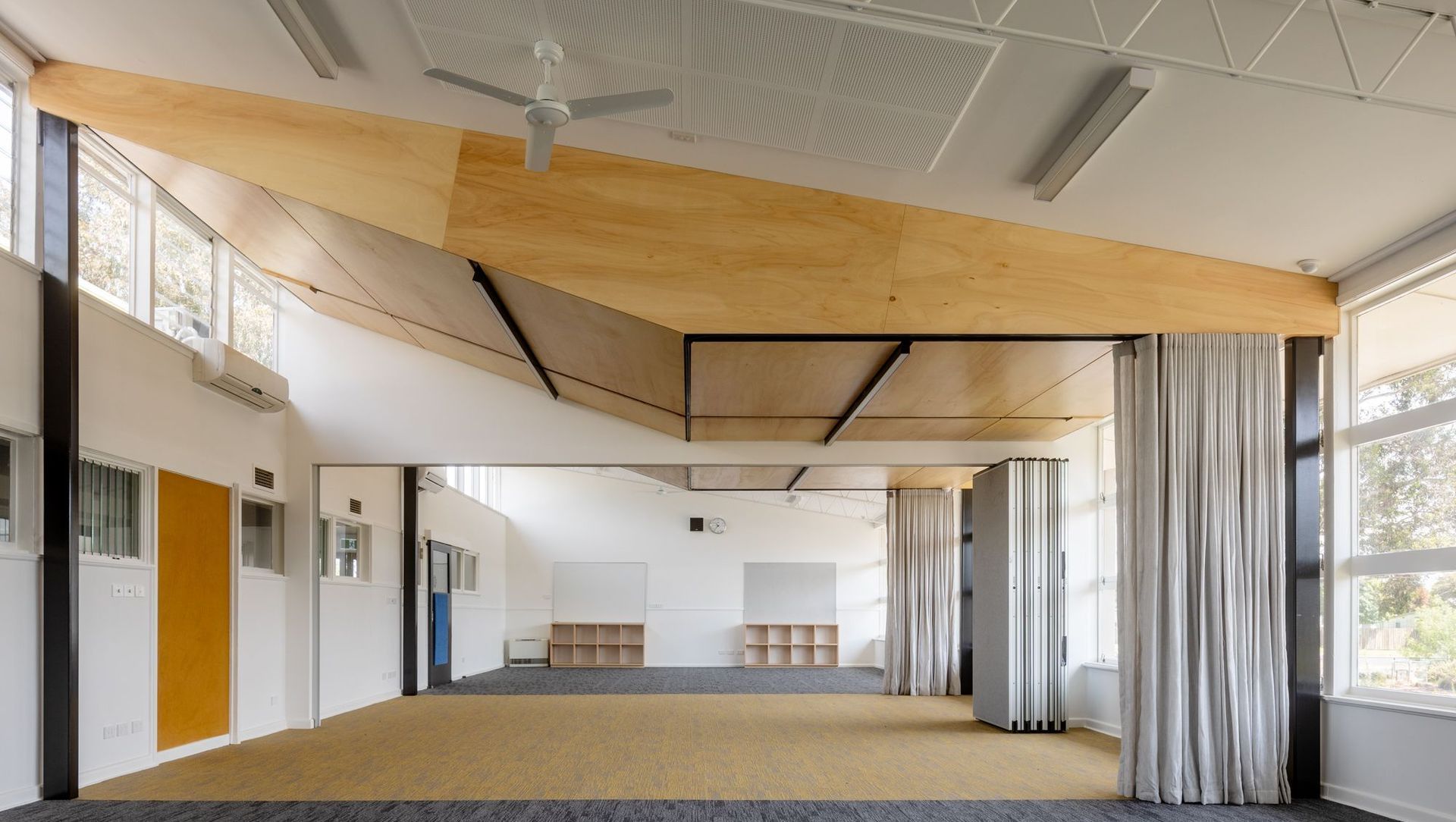 Light wood panelling, integrated lights and provide a bright learning space