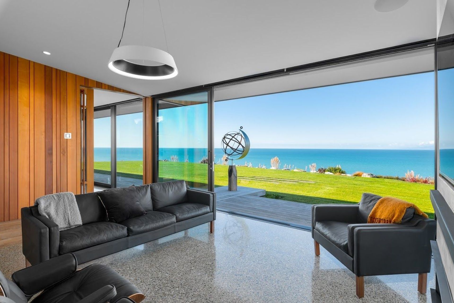 A spherical sculpture on the front lawn can be seen directly from the lobby area on arrival .