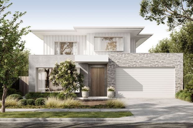 Front exterior view of a contemporary two-storey suburban residence with a layered flat roof, white vertical cladding, grey rendered walls, a grey stone-clad garage volume, timber-look entry door, and a wide sectional garage door. Low-maintenance landscaping and a concrete driveway frame the facade.