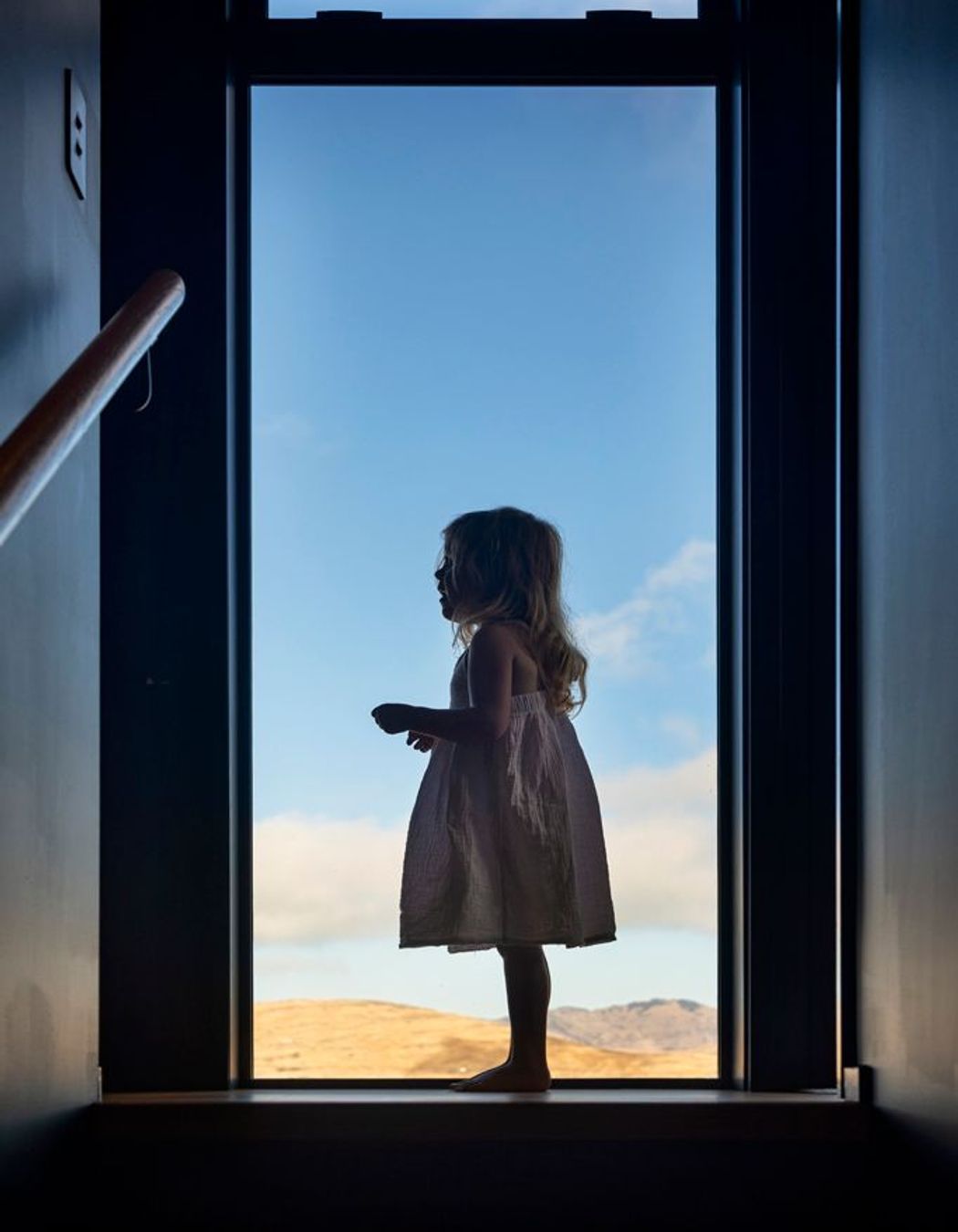 Floor-to-ceiling windows frame the wide-reaching views.