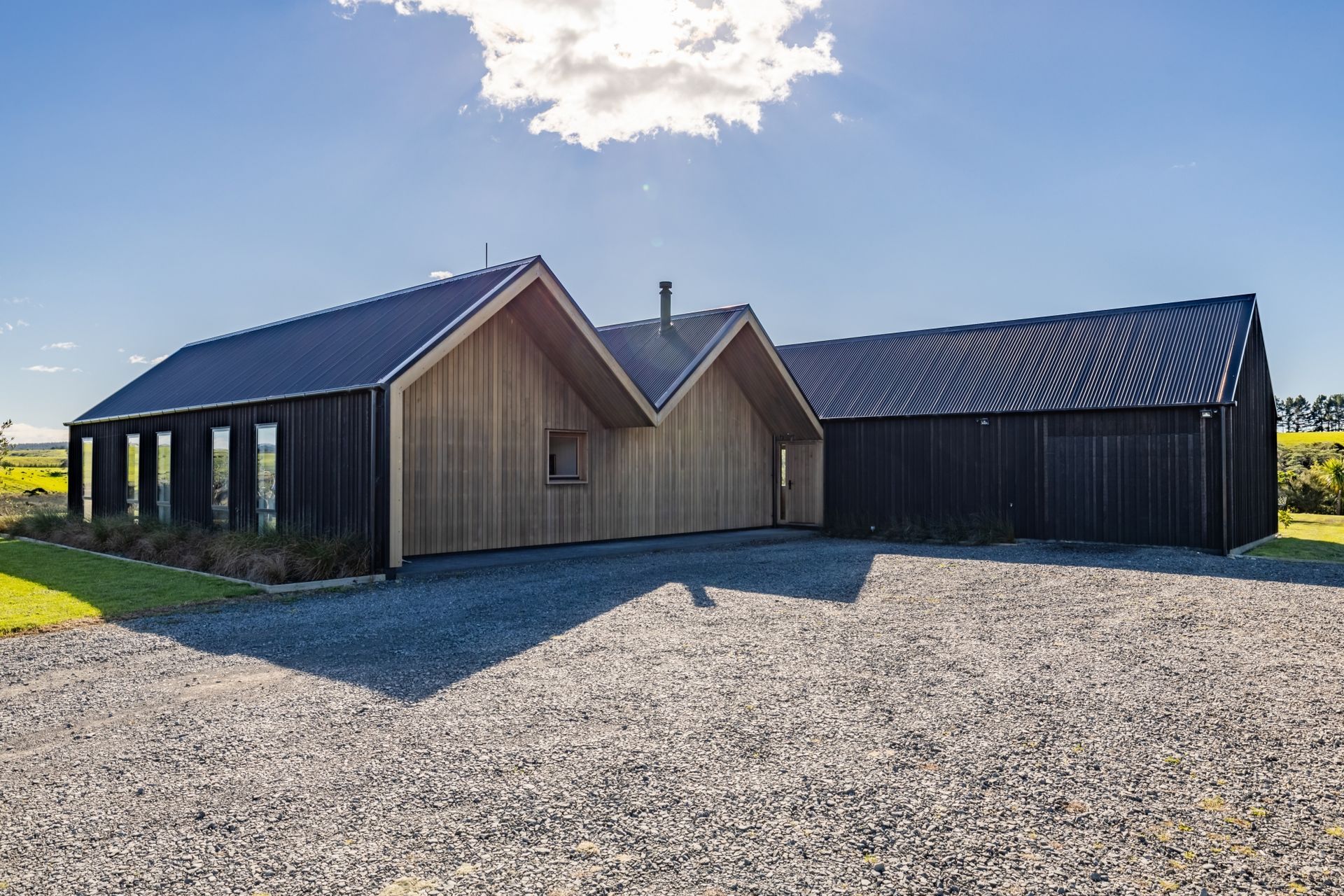 The clients had a specific desire for a repeating gable form and for a building that, "on approach, is not obviously a dwelling, perhaps appearing to be a farm building."
