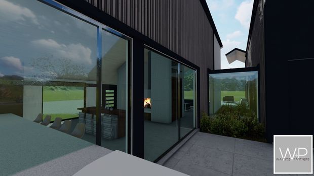 A contemporary dark-clad house rendered from an exterior courtyard or terrace. Large black-framed floor-to-ceiling glazed openings reveal a modern interior with a dining area and fireplace, while a concrete-paved path and planted courtyard sit between the building wings. The design has strong linear forms, a pitched roofline, and an enclosed glazed connection between volumes.