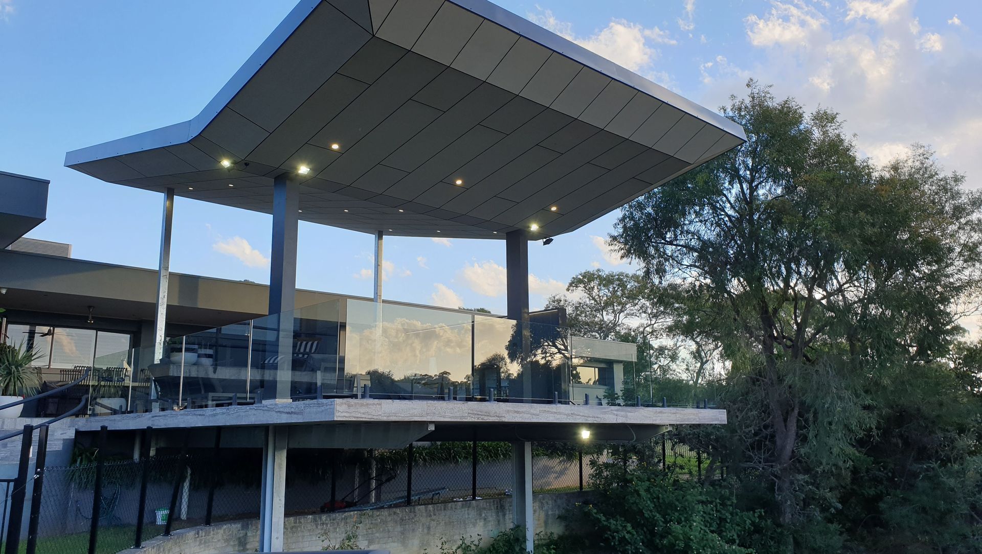 Annangrove Patio: Butterfly Roof Framing Mountainous Views banner