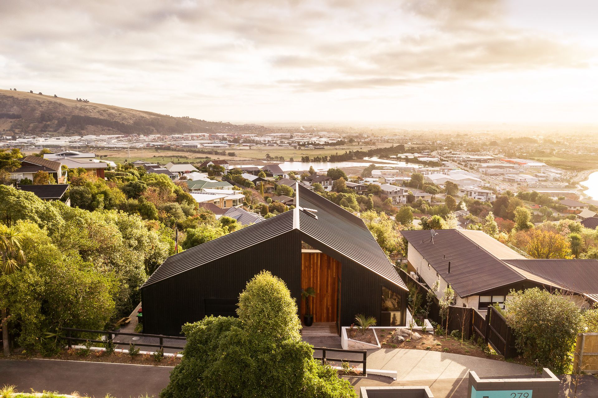 From the street, the house presents a rather humble, barn-like facade, which subtly references the design intent within the home.