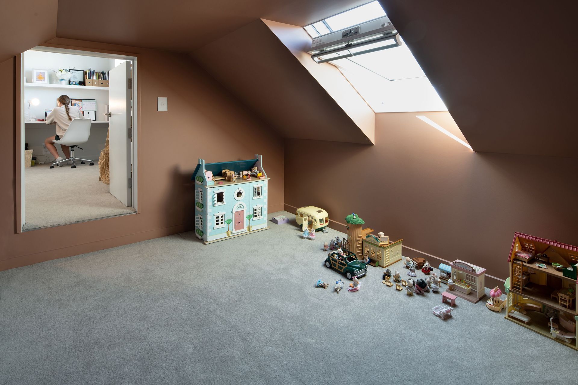A bedroom opens to a play space above the garage.