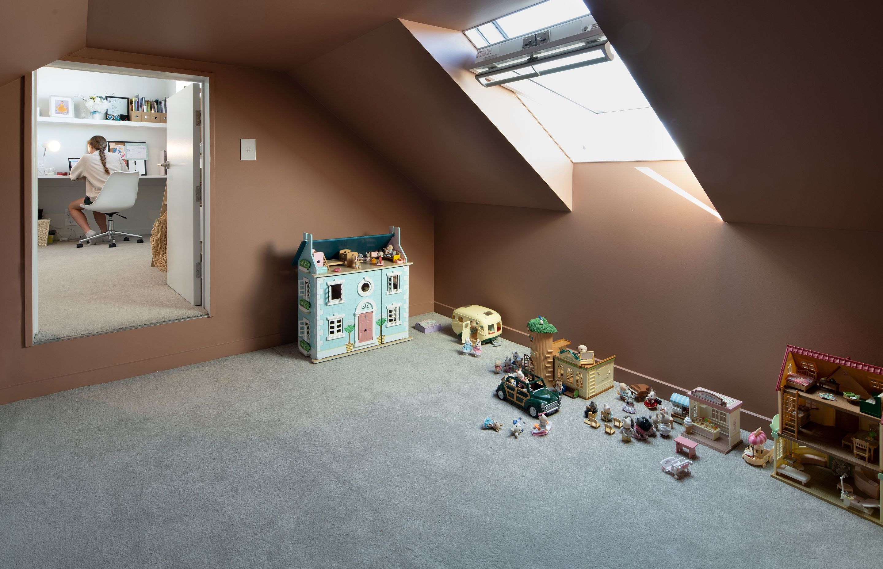 A bedroom opens to a play space above the garage.