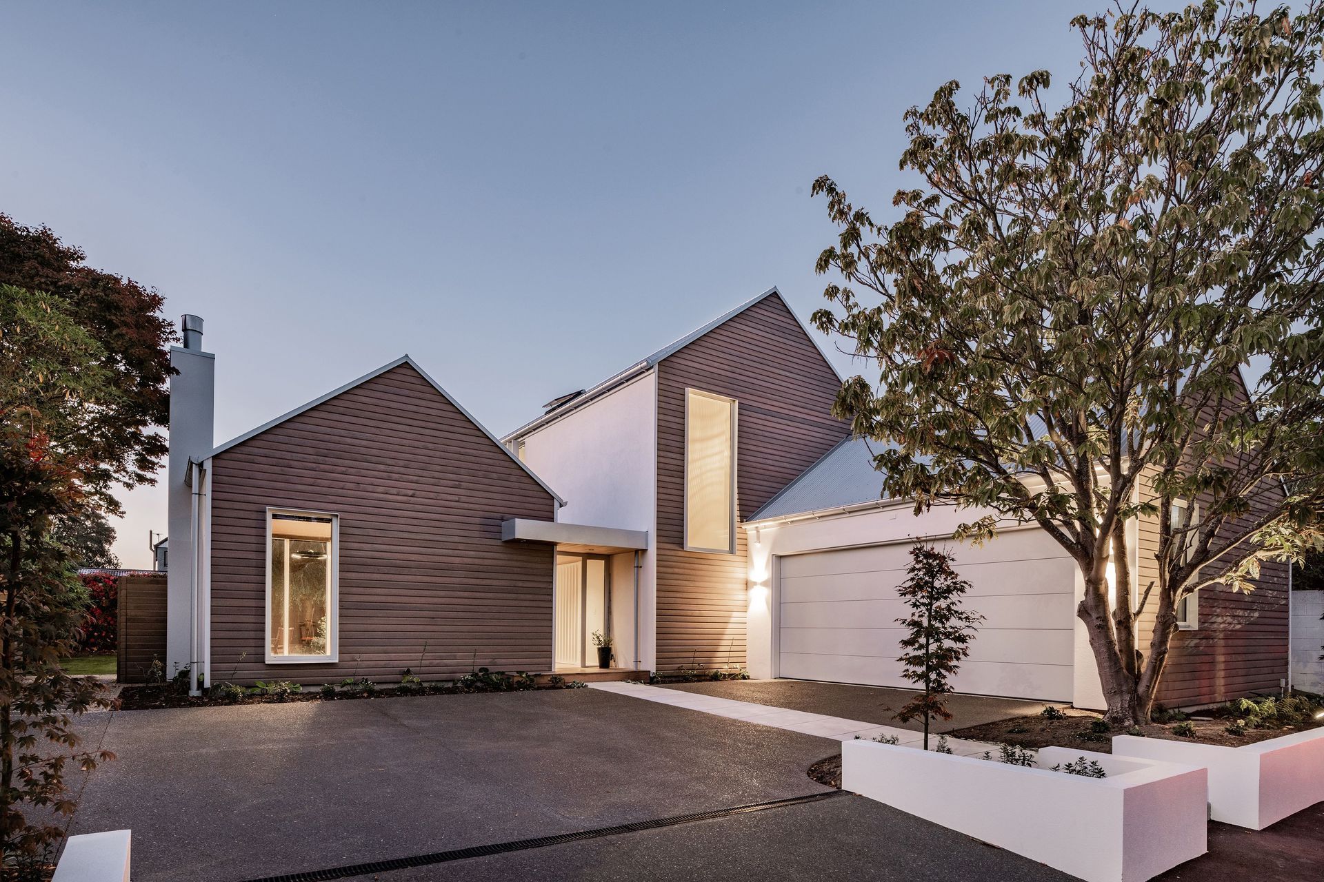 The homeowners wanted the build to complement the existing character homes on the street – cedar-clad gable forms achieve this.