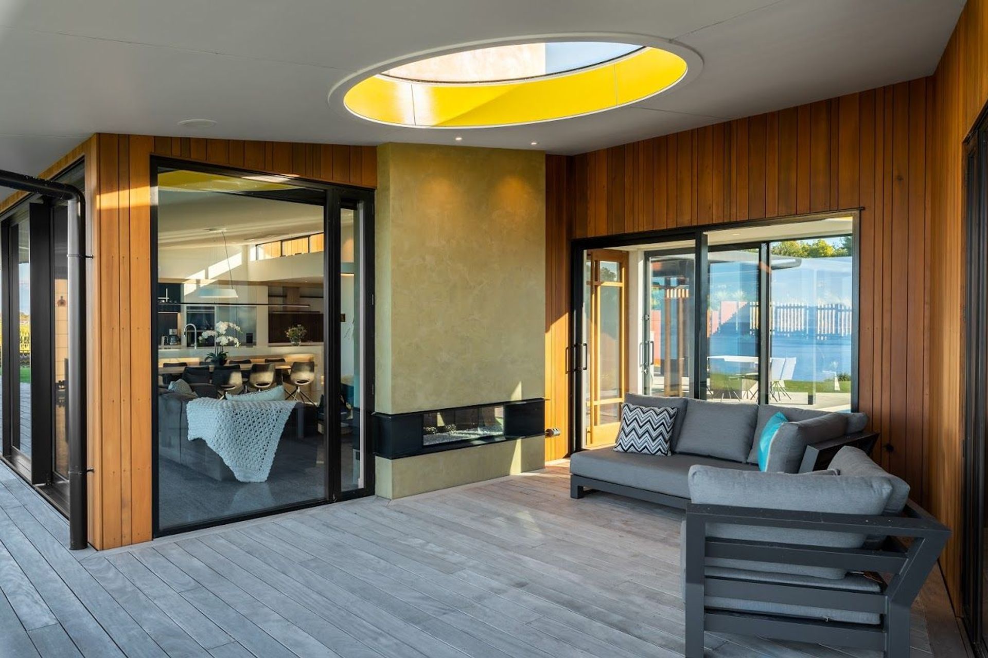 Huge round glazed atriums are integrated into the roof plane on each side of the central module.