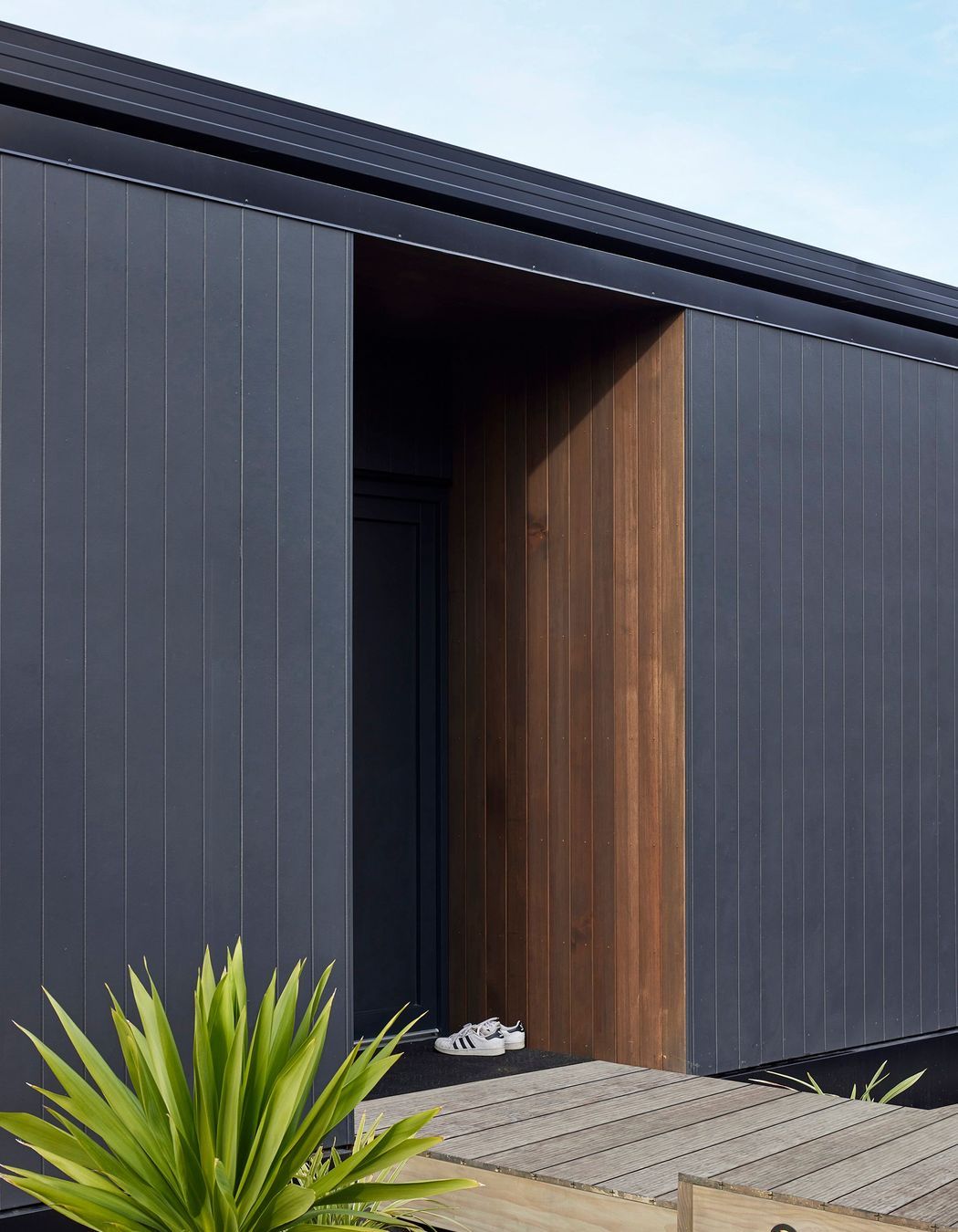 Sheltered entry space opening directly from street