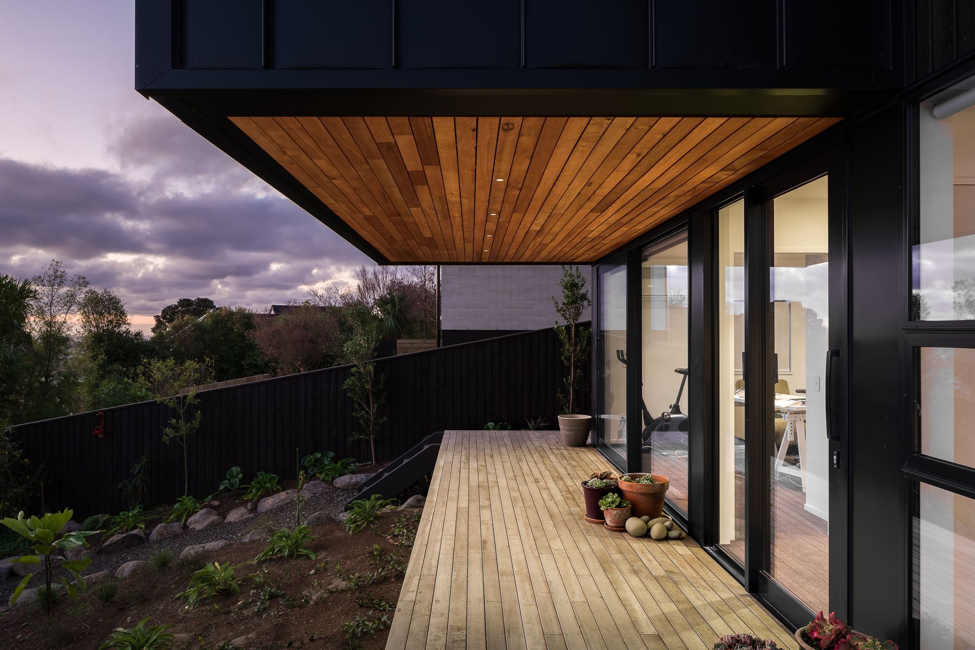 A small balcony connects the downstairs guest accommodations with the backyard.
