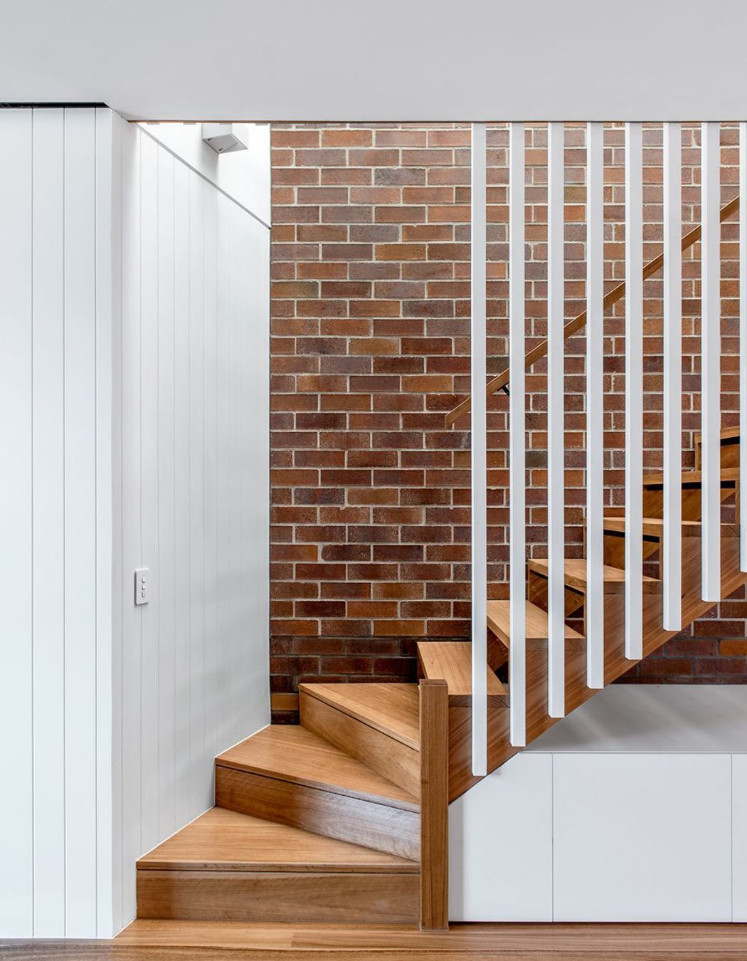 Photography: Cathy Schusler | Combining solid and lightweight construction, the three new dwellings mesh the qualities of the traditional terrace house with those of the Queenslander. Locally sourced face brick are used in Party walls, with floors and ext