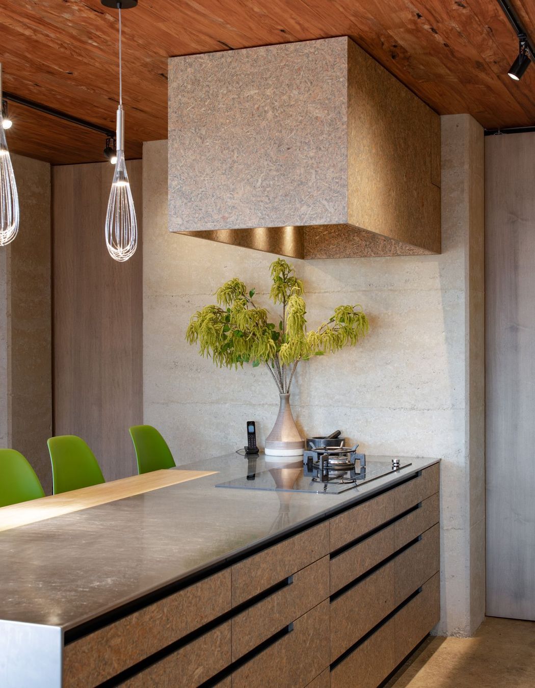 Strand board, a material not usually associated with residential architecture, was chosen for the kitchen cabinetry.