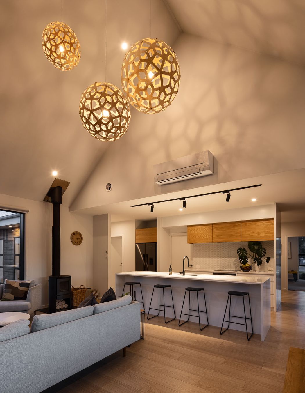 Soaring cathedral ceilings create a dramatic sense of volumetric space in the open-plan living area, which is only revealed once you step into the space.