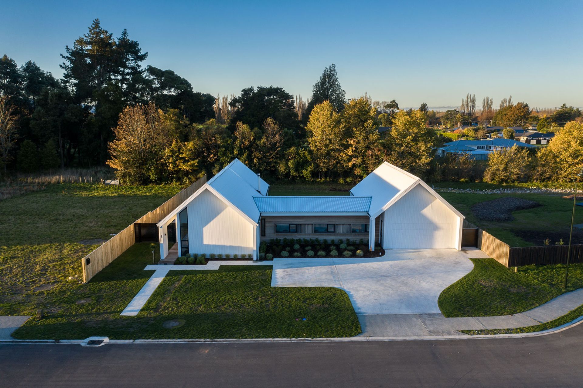 Comprising two gabled pavilions linked by a connecting element, the generously proportioned home features four bedrooms and multiple living areas.