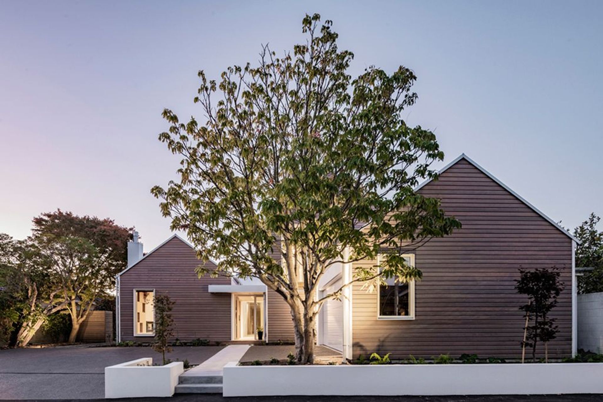 The large existing tree at the front of the home was preserved during the build.