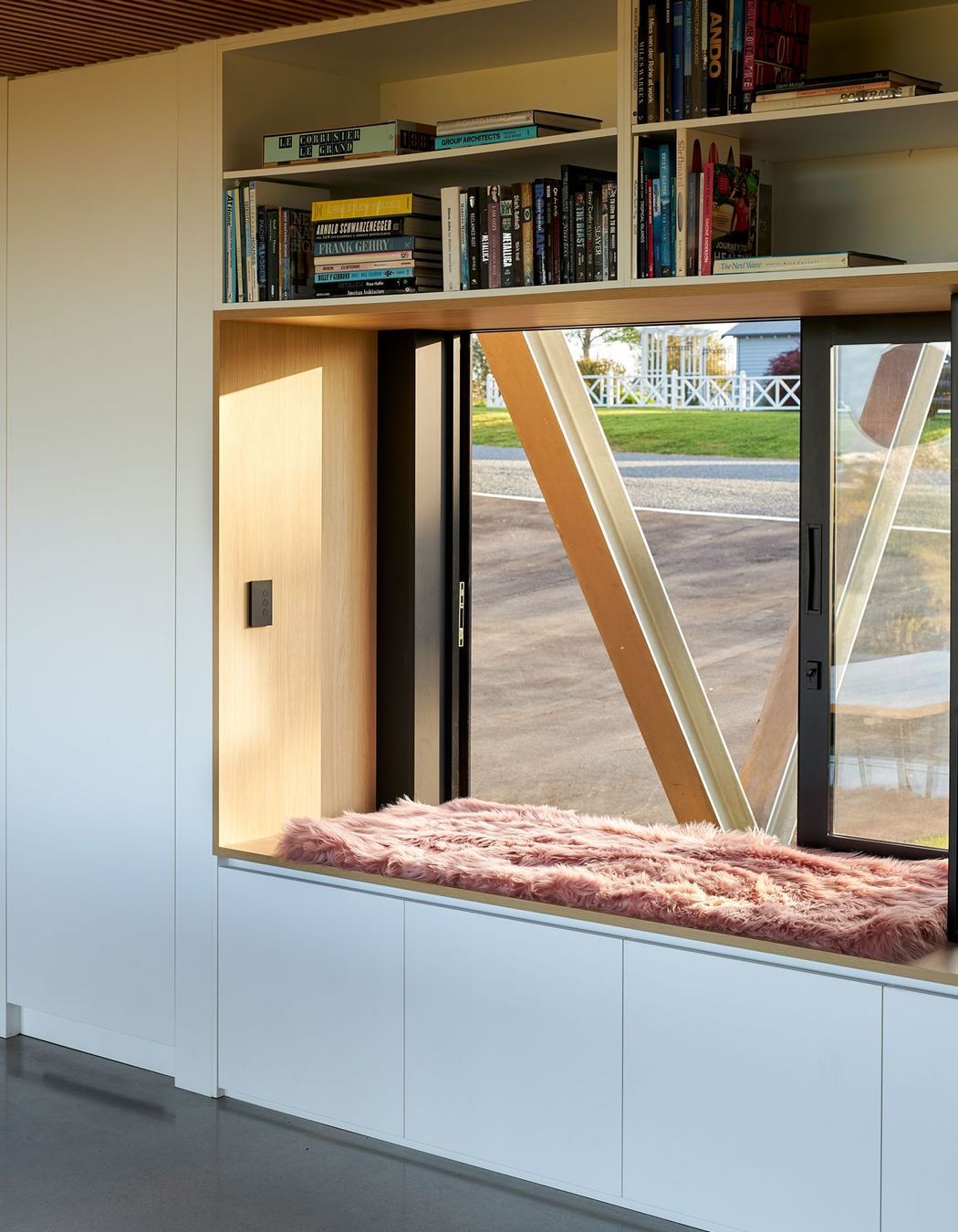 A large window with generous window seat offers a perch on the western side of the house, continuing the theme of openness and interaction with the surroundings.