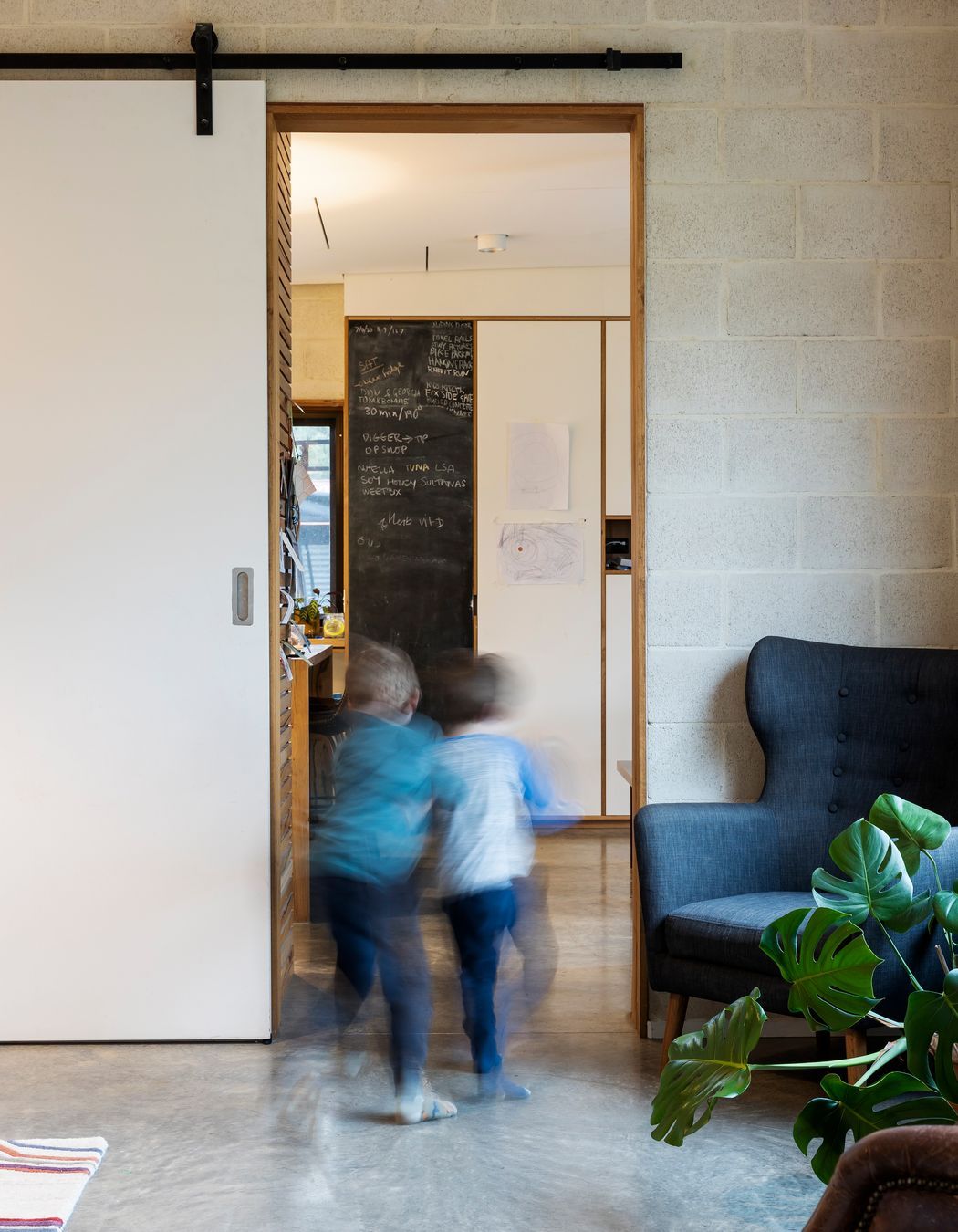 Barn-style sliding doors provide acoustic and thermal separation between living areas