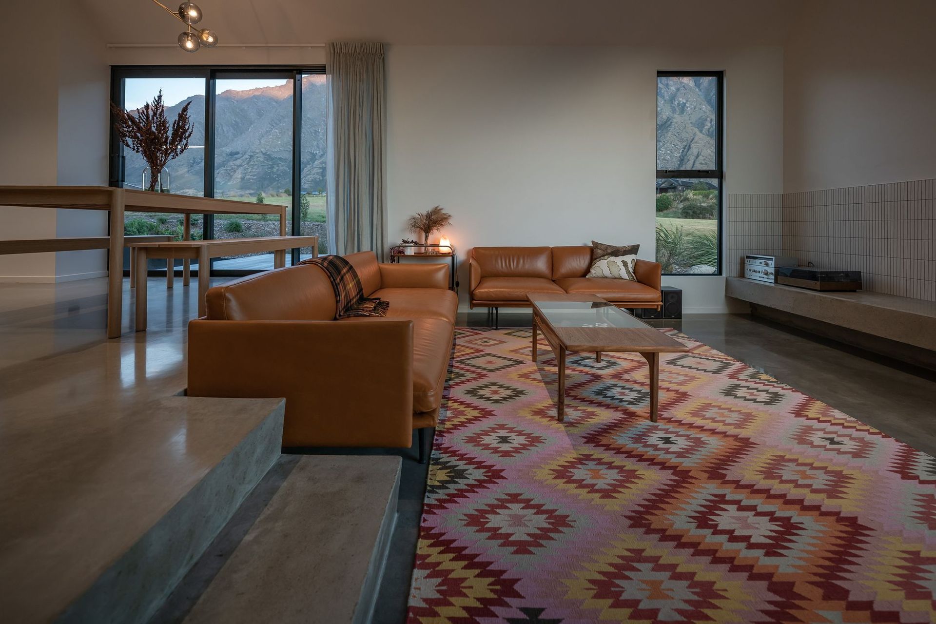 The sunken lounge is accessed through in situ concrete stairs at the rear of the dining space. An external deck at the back of the lounge is a perfect spot to catch the evening sun.