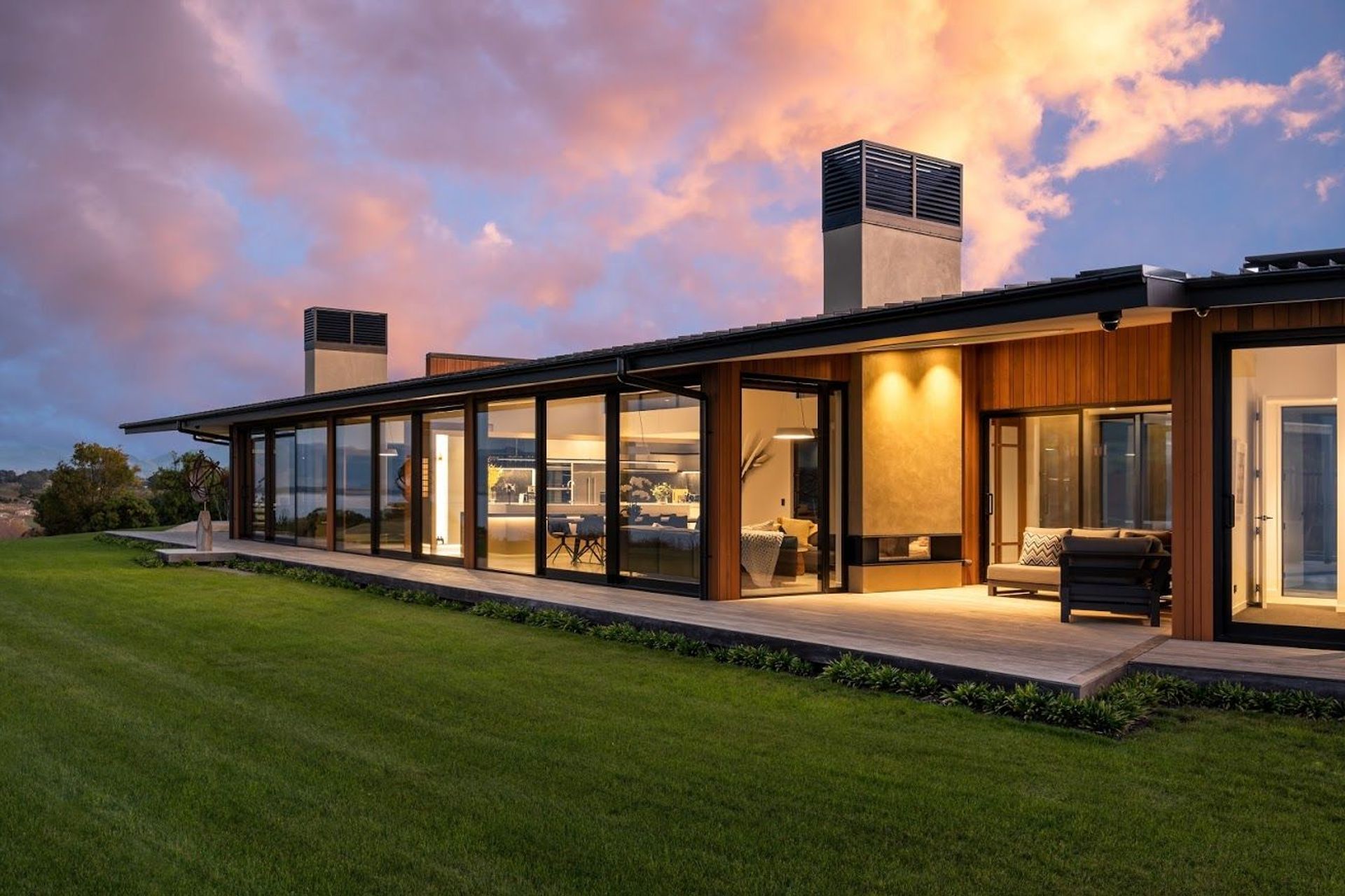 The central module is sandwiched between two chimneys, each with a sheltered outdoor nook.