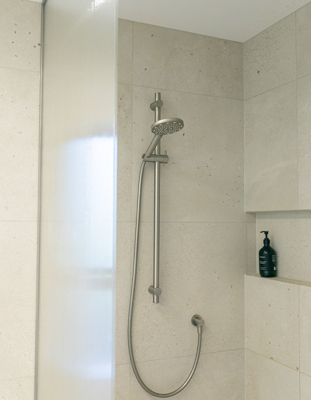 Texture and neutral colours combine in the shower spaces.