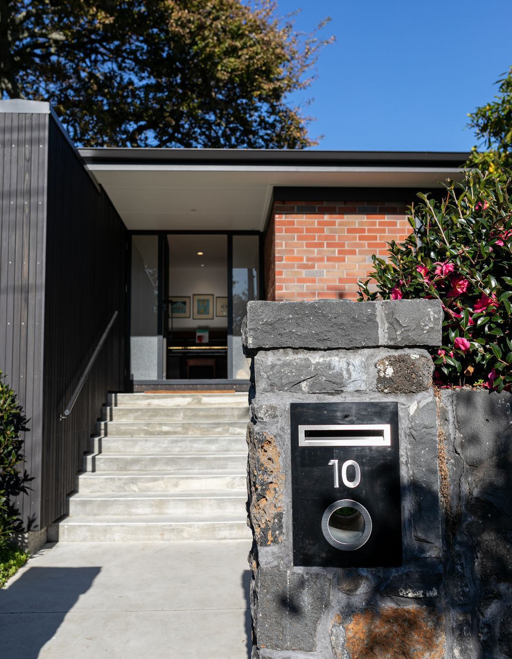 The contrast of old and new is experienced from the front of the dwelling.