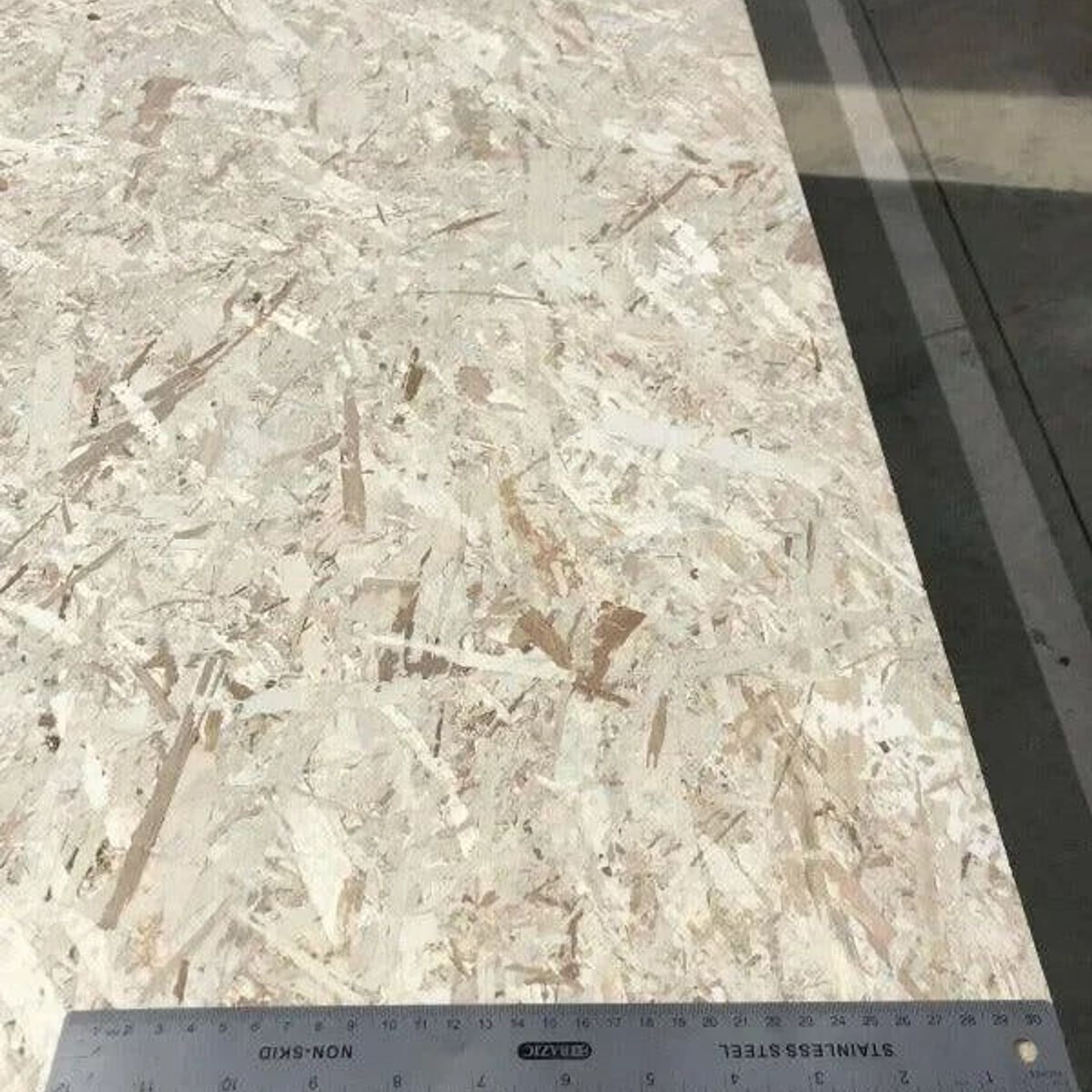 Italian Poplar OSB3 board with a ruler - Ply Online
