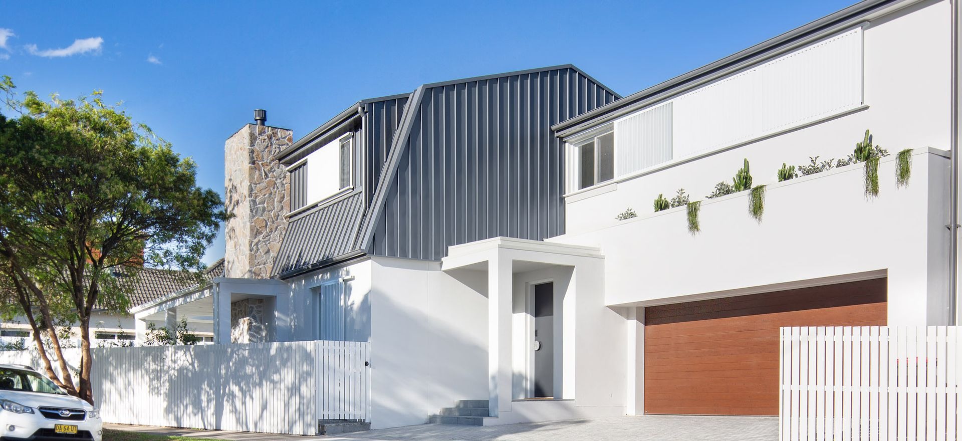 Barn House celebrates grounded, intentional architecture with natural stone material palette