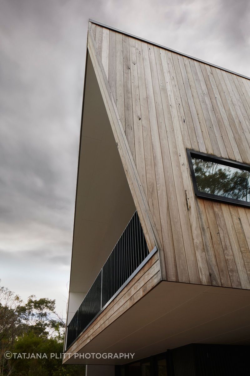 Recycled red ironbark cladding has been left to age naturally and blend with the surrounding environment.