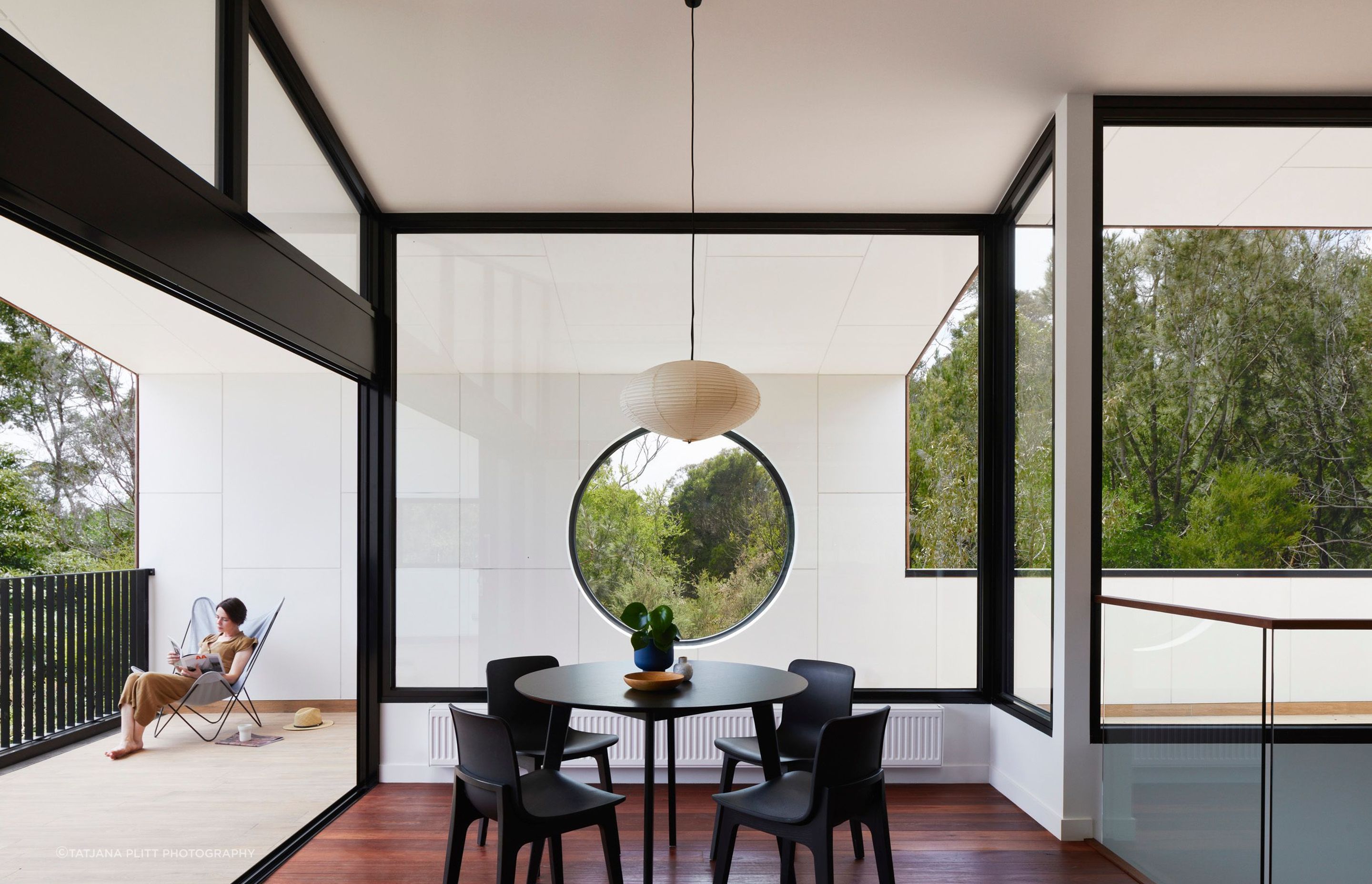 The view captured in the round window can be enjoyed from the dining area.