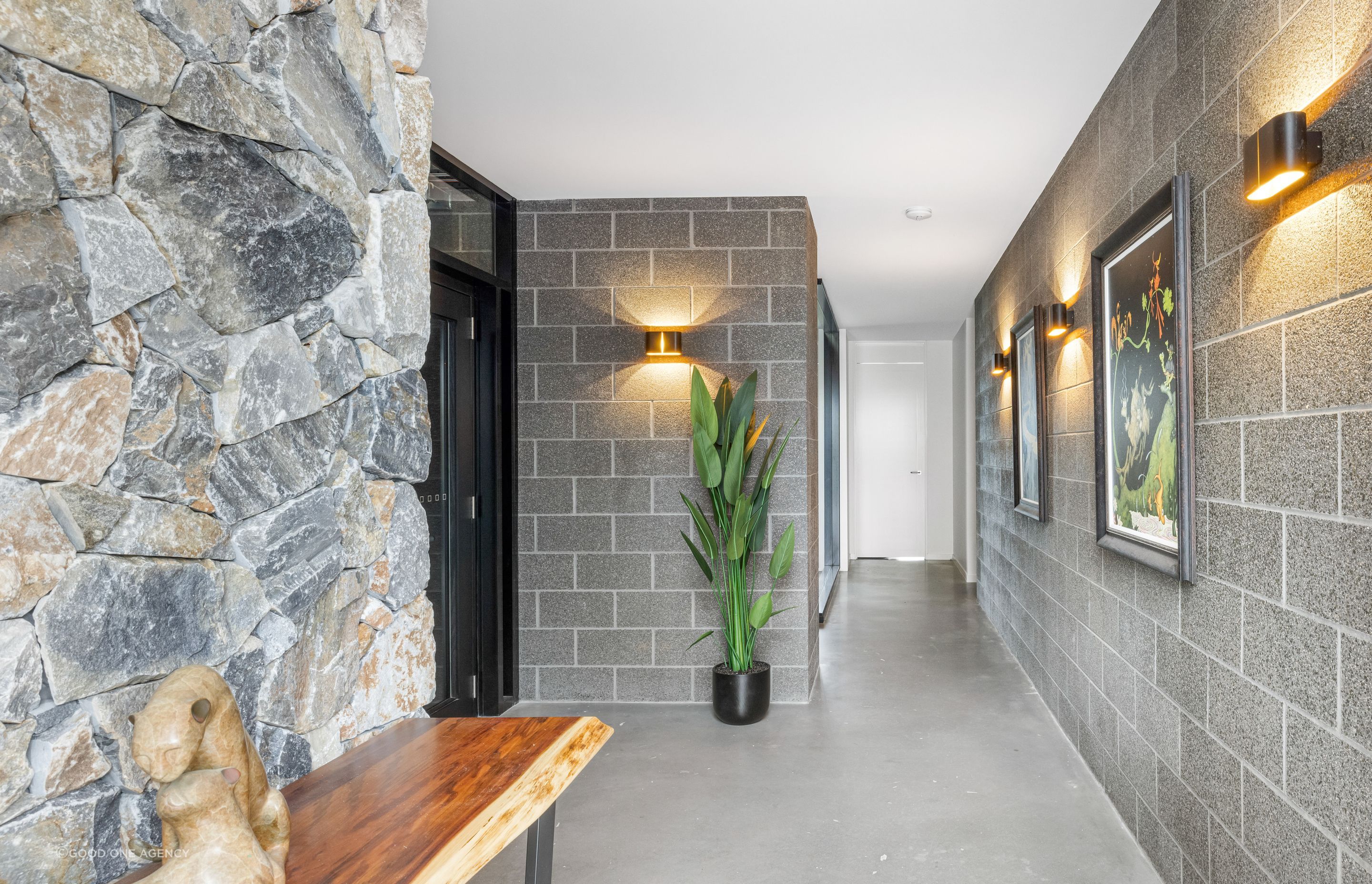 The stone walls and blockwork weave in from outside, creating a seamless transition between interior and exterior.