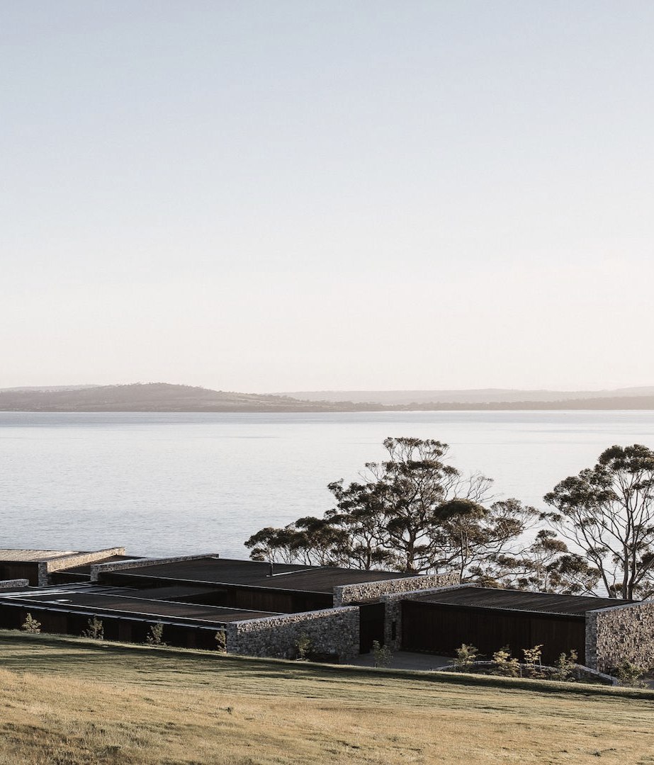 A cliffside home of wood and stone at one with the Tasmanian landscape